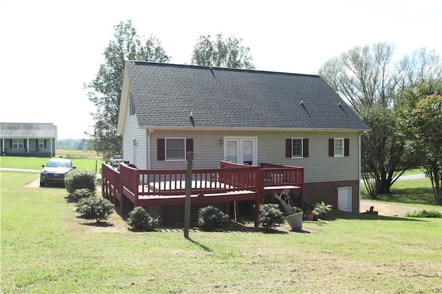 rear view of house featuring a yard and a wooden deck