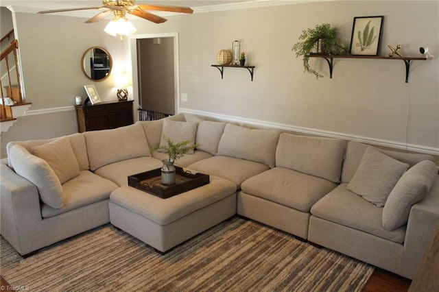 living room with hardwood / wood-style flooring, ceiling fan, and crown molding