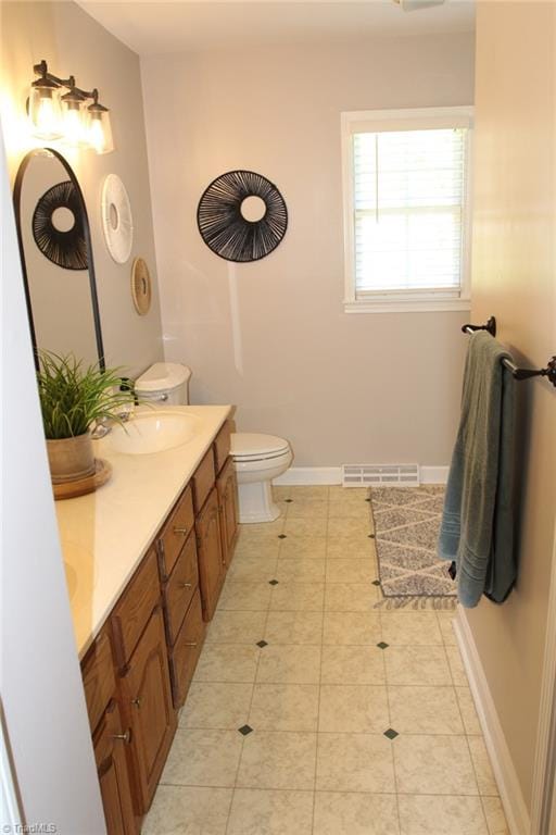 bathroom featuring toilet and vanity