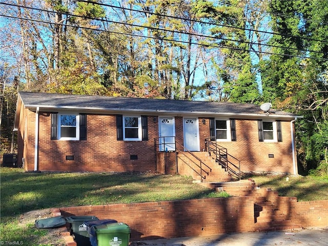 single story home with a front yard and central AC unit