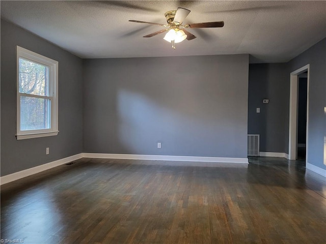 spare room featuring ceiling fan, dark hardwood / wood-style flooring, and a textured ceiling