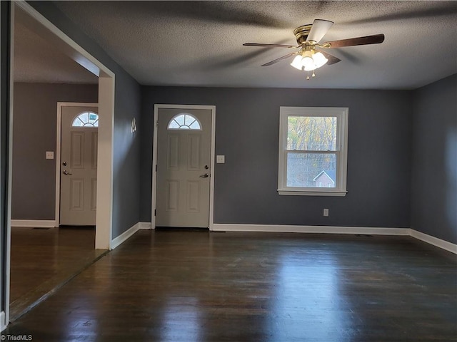 entrance foyer with ceiling fan, dark hardwood / wood-style flooring, and a textured ceiling