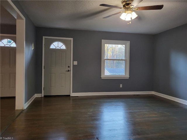 entrance foyer with ceiling fan, dark hardwood / wood-style flooring, and a textured ceiling