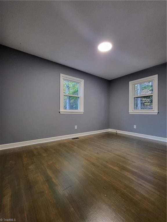 empty room with dark hardwood / wood-style floors