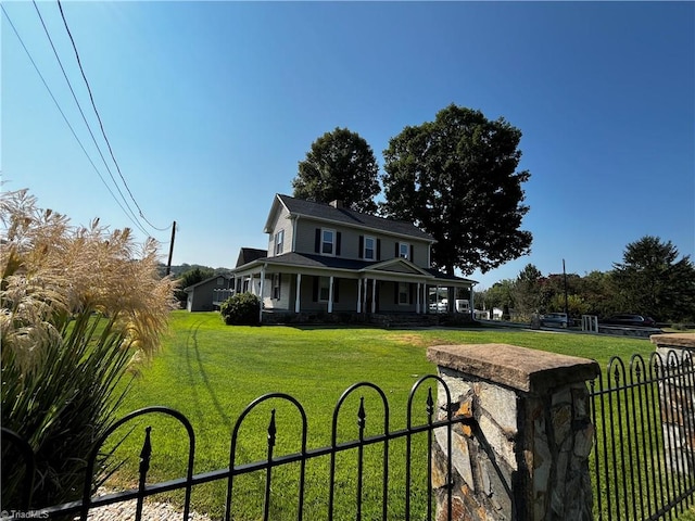 farmhouse with covered porch and a front lawn