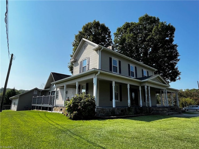 farmhouse-style home with covered porch and a front lawn