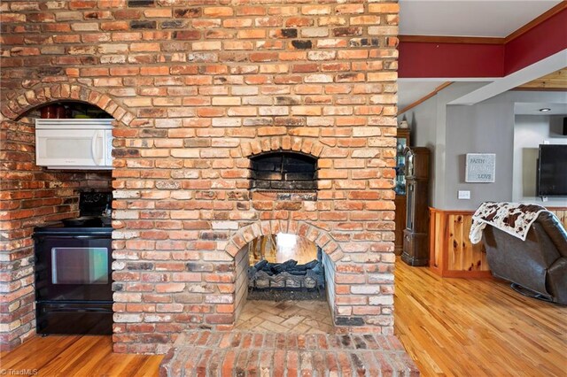 unfurnished living room featuring ornamental molding and light hardwood / wood-style flooring