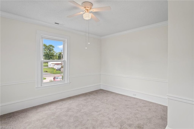 spare room featuring ceiling fan, carpet, and ornamental molding