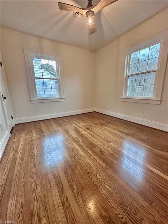 1214 Fillman Dr, Reidsville, NC 27320 - empty room featuring a ceiling fan, baseboards, and wood finished floors