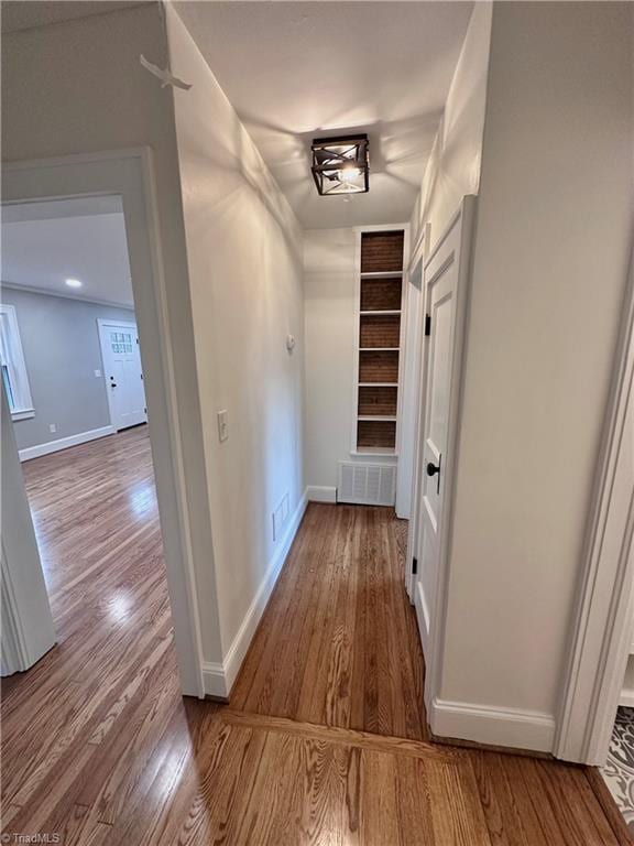 1214 Fillman Dr, Reidsville, NC 27320 - corridor with visible vents, built in shelves, and wood finished floors