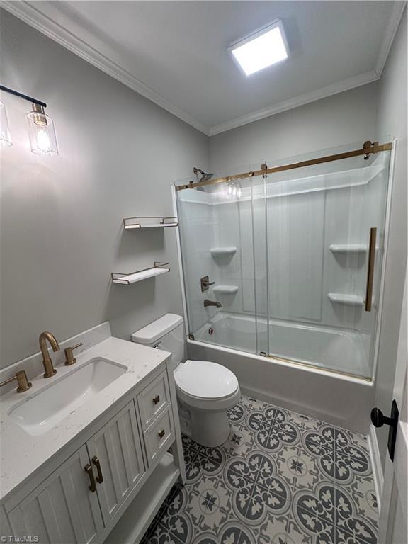 1214 Fillman Dr, Reidsville, NC 27320 - bathroom with vanity, tub / shower combination, ornamental molding, tile patterned flooring, and toilet