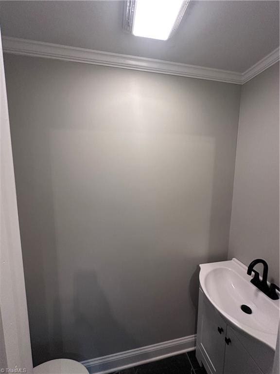 1214 Fillman Dr, Reidsville, NC 27320 - bathroom with baseboards, toilet, ornamental molding, and vanity