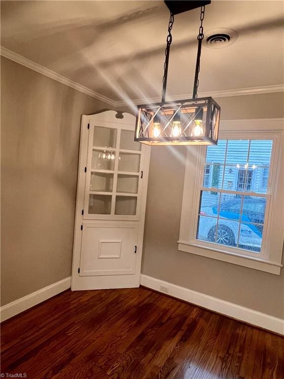 1214 Fillman Dr, Reidsville, NC 27320 - unfurnished dining area featuring dark wood-style floors, baseboards, and ornamental molding