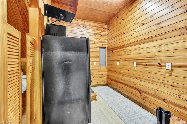 office space with wooden walls, tile patterned floors, and electric panel