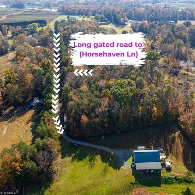 drone / aerial view featuring a view of trees