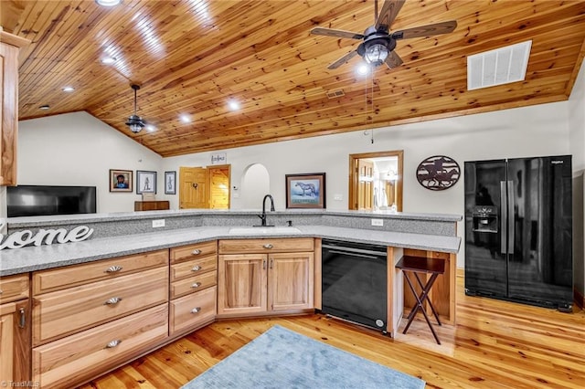 kitchen featuring visible vents, wood ceiling, a sink, black appliances, and vaulted ceiling