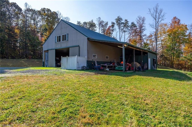 view of pole building with a yard and driveway