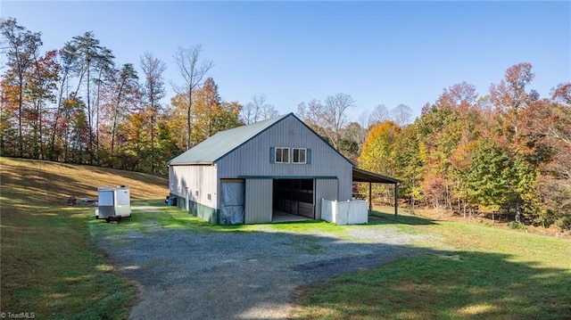 garage with driveway and a detached garage