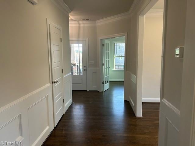 hall with ornamental molding and dark hardwood / wood-style flooring