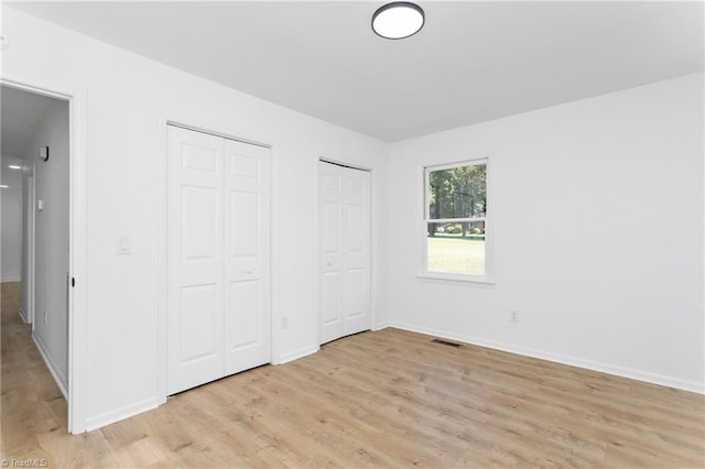 2282 Valewood Dr, Asheboro, NC 27205 - unfurnished bedroom with multiple closets and light wood-style floors