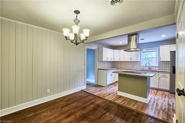 kitchen featuring a sink, stainless steel fridge, island exhaust hood, white cabinets, and dark wood finished floors