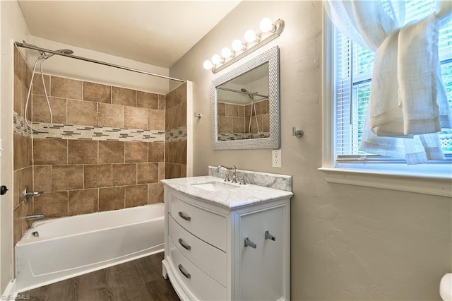 full bathroom featuring wood finished floors, bathtub / shower combination, and vanity