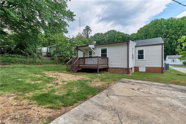 rear view of property featuring a deck, crawl space, and central AC unit