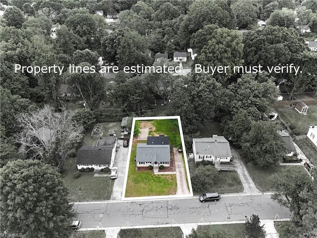 aerial view of property and surrounding area featuring property parcel outlined