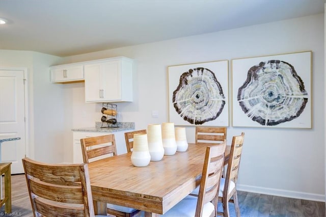 dining area featuring dark wood-type flooring