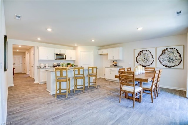 dining room featuring light hardwood / wood-style flooring