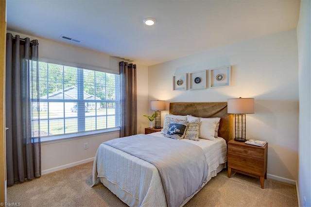 bedroom featuring light colored carpet