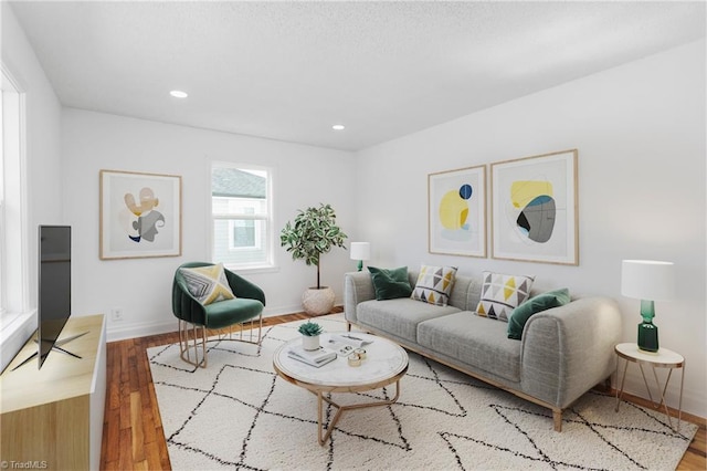 living room with recessed lighting, baseboards, and wood finished floors