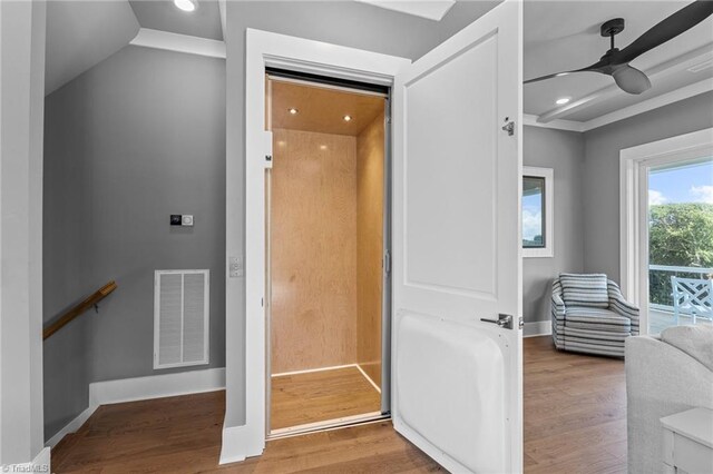 interior space featuring hardwood / wood-style floors, elevator, and ceiling fan