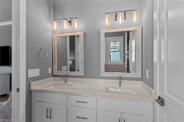 bathroom with double vanity and wood-type flooring