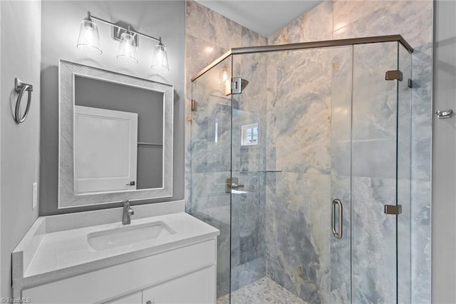 bathroom featuring vanity and a shower with door