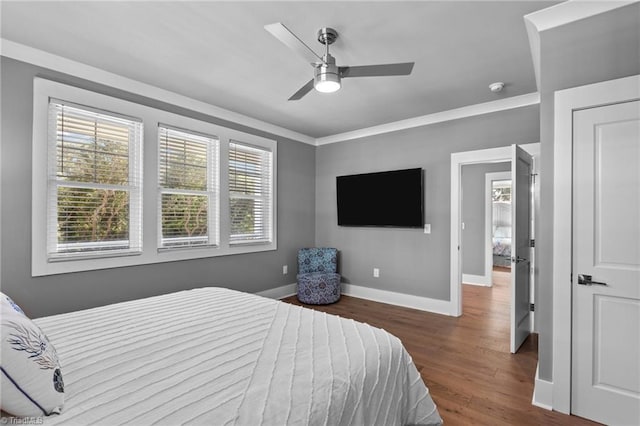 bedroom with ornamental molding, ceiling fan, and hardwood / wood-style floors