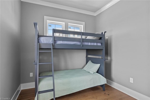 bedroom featuring crown molding and hardwood / wood-style floors