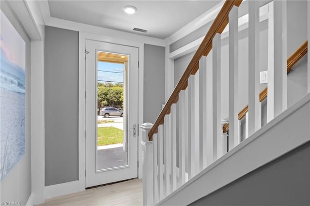 foyer entrance featuring light hardwood / wood-style floors and a wealth of natural light