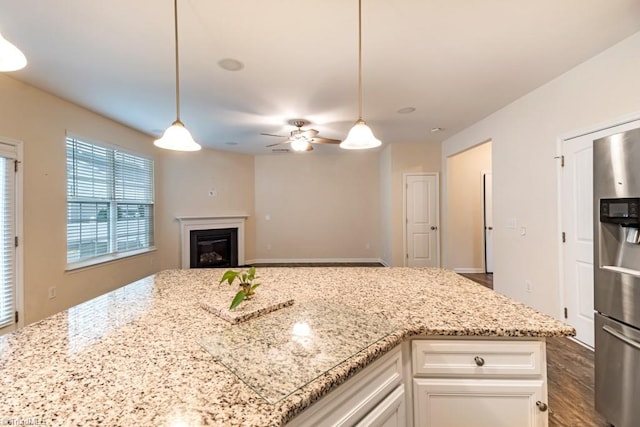 1881 Huntley Way, Burlington, NC 27215 - kitchen with stainless steel refrigerator with ice dispenser, light stone counters, ceiling fan, white cabinets, and pendant lighting