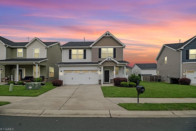 1881 Huntley Way, Burlington, NC 27215 - traditional-style house with board and batten siding, concrete driveway, an attached garage, a yard, and covered porch