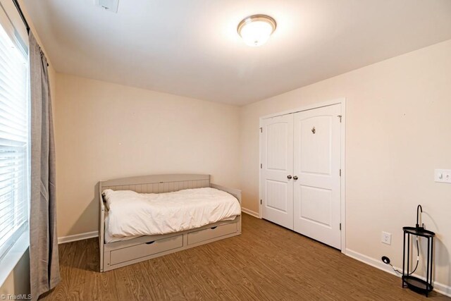1881 Huntley Way, Burlington, NC 27215 - bedroom with wood finished floors, multiple windows, and baseboards
