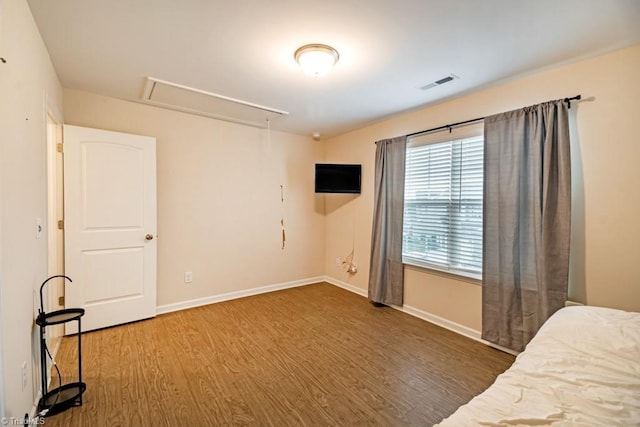 1881 Huntley Way, Burlington, NC 27215 - unfurnished bedroom with attic access, wood finished floors, and baseboards