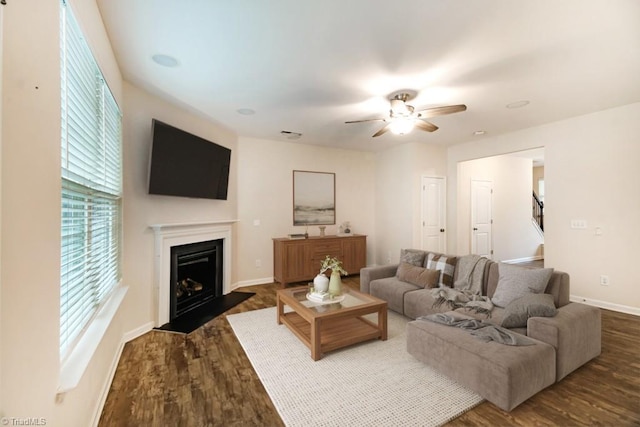 1881 Huntley Way, Burlington, NC 27215 - living area with dark wood finished floors, a fireplace with flush hearth, a ceiling fan, baseboards, and stairway