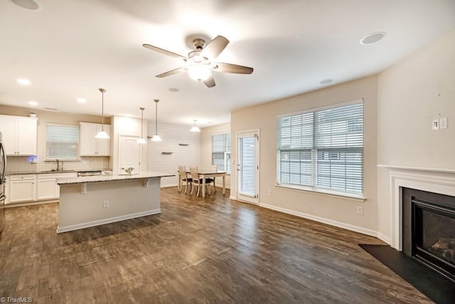 1881 Huntley Way, Burlington, NC 27215 - kitchen with a sink, ceiling fan, a breakfast bar area, white cabinets, and a center island