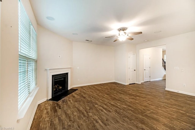 1881 Huntley Way, Burlington, NC 27215 - unfurnished living room featuring a ceiling fan, dark wood-style floors, a fireplace with flush hearth, and baseboards