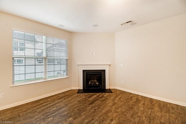 1881 Huntley Way, Burlington, NC 27215 - unfurnished living room featuring wood finished floors, baseboards, and a fireplace with flush hearth
