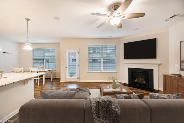 1881 Huntley Way, Burlington, NC 27215 - living room with ceiling fan, dark wood finished floors, baseboards, and a glass covered fireplace