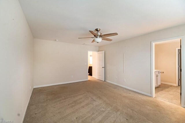 1881 Huntley Way, Burlington, NC 27215 - unfurnished bedroom featuring light colored carpet, baseboards, connected bathroom, and a ceiling fan