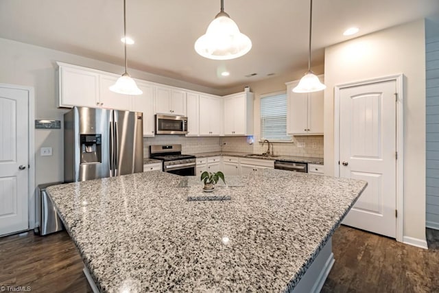 1881 Huntley Way, Burlington, NC 27215 - kitchen featuring appliances with stainless steel finishes, a sink, white cabinets, a center island, and recessed lighting