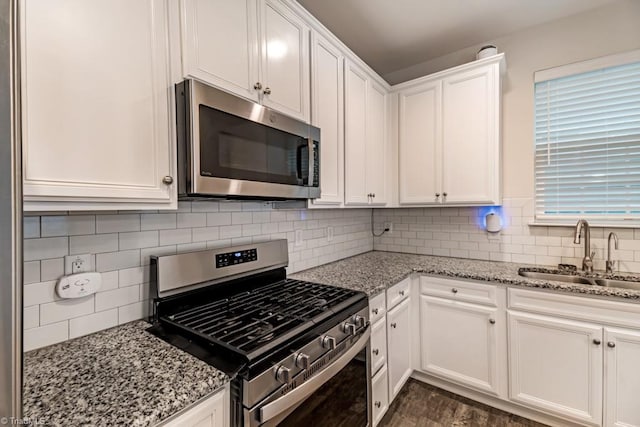 1881 Huntley Way, Burlington, NC 27215 - kitchen featuring appliances with stainless steel finishes, a sink, white cabinetry, and light stone counters